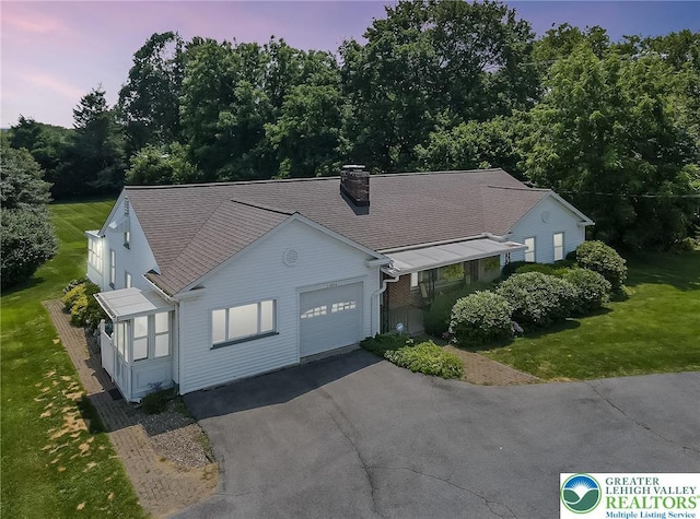 2930 Green Pond, Palmer Twp, PA 18045 - view of front of property featuring an attached garage, asphalt driveway, a front yard, roof with shingles, and a chimney