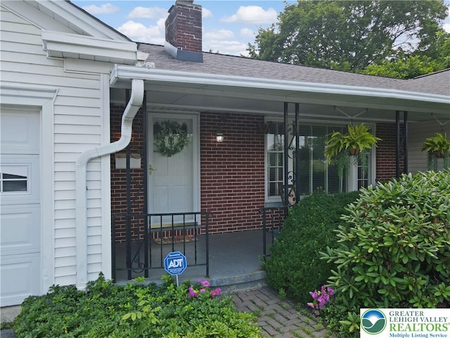 2930 Green Pond, Palmer Twp, PA 18045 - property entrance featuring a chimney, roof with shingles, brick siding, and a porch