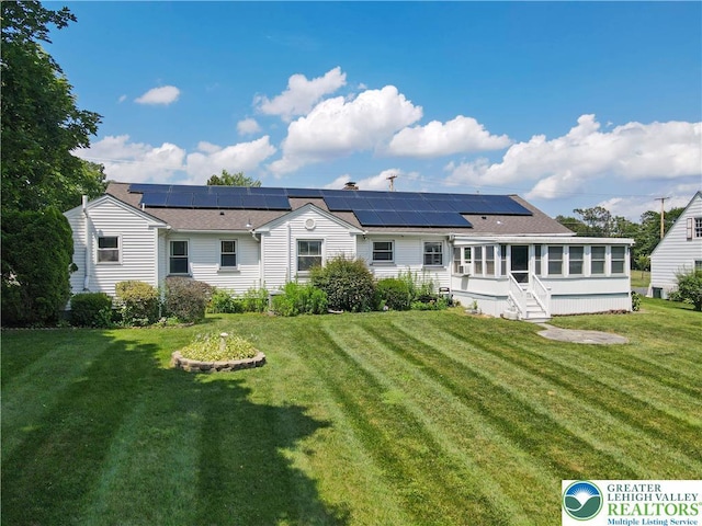 2930 Green Pond, Palmer Twp, PA 18045 - rear view of house with a sunroom, solar panels, and a yard