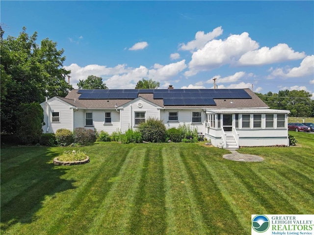 2930 Green Pond, Palmer Twp, PA 18045 - back of house featuring roof mounted solar panels, a lawn, and a sunroom