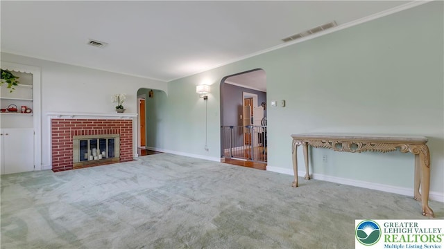 2930 Green Pond, Palmer Twp, PA 18045 - unfurnished living room with arched walkways, carpet flooring, ornamental molding, and a brick fireplace