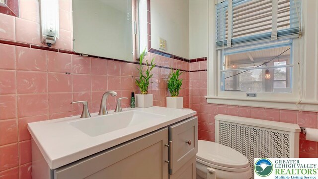 2930 Green Pond, Palmer Twp, PA 18045 - bathroom featuring radiator, vanity, and tile walls