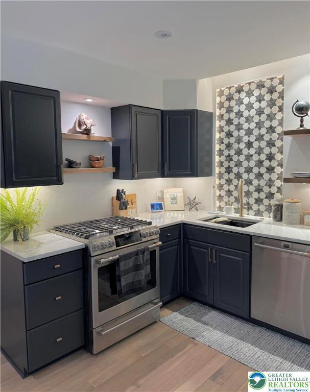 12 Concord Ct, Easton, PA 18040 - kitchen featuring stainless steel appliances, open shelves, and light wood finished floors
