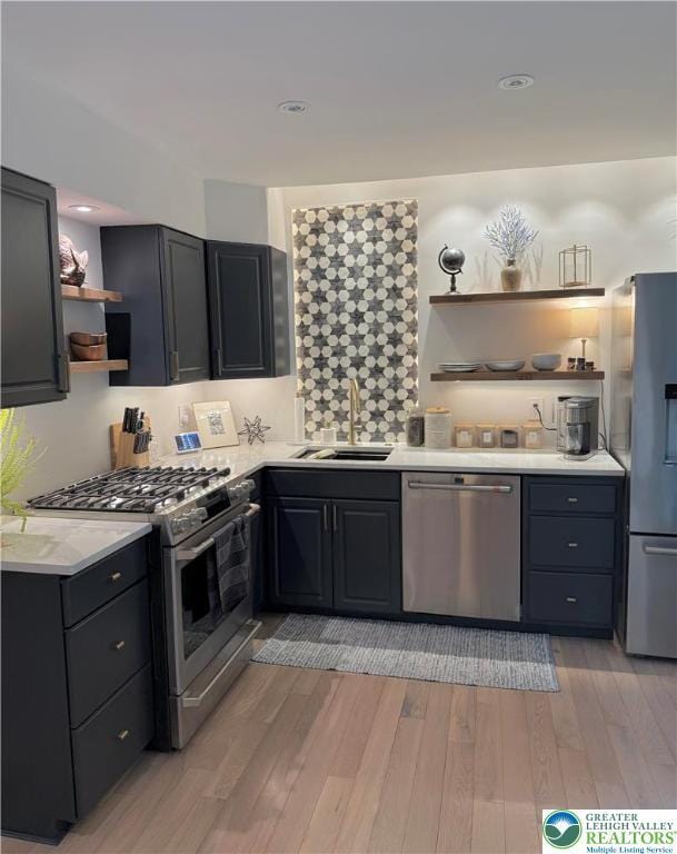 12 Concord Ct, Easton, PA 18040 - kitchen with open shelves, stainless steel appliances, light countertops, and light wood-style flooring