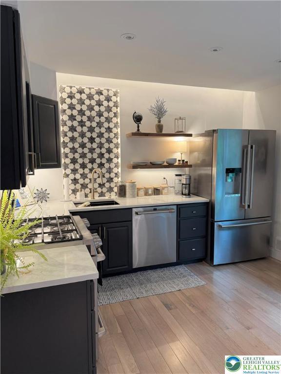 12 Concord Ct, Easton, PA 18040 - kitchen featuring appliances with stainless steel finishes, light countertops, light wood-type flooring, and dark cabinetry