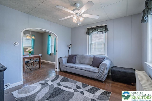 858 Radclyffe St, Bethlehem City, PA 18017 - living room with radiator, arched walkways, wood finished floors, and a ceiling fan