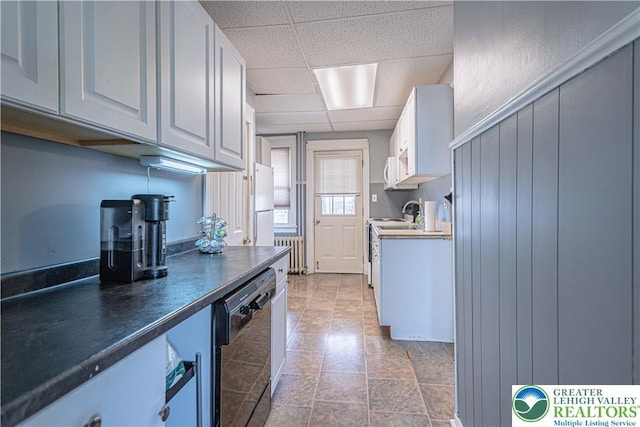 858 Radclyffe St, Bethlehem City, PA 18017 - kitchen with radiator, black dishwasher, a paneled ceiling, dark countertops, and range