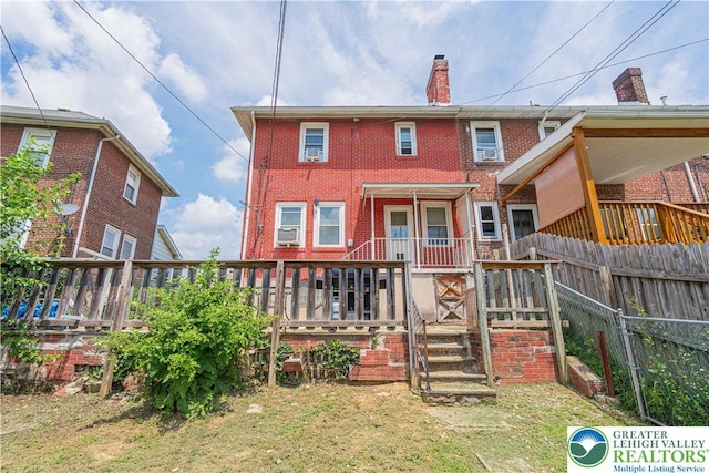 858 Radclyffe St, Bethlehem City, PA 18017 - rear view of property with brick siding, a chimney, and cooling unit