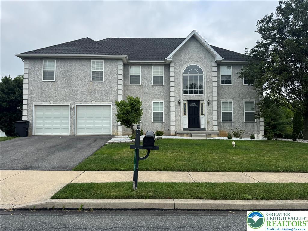 118 Walker Dr, Allen Twp, PA 18067 - colonial-style house with asphalt driveway, an attached garage, and a front yard