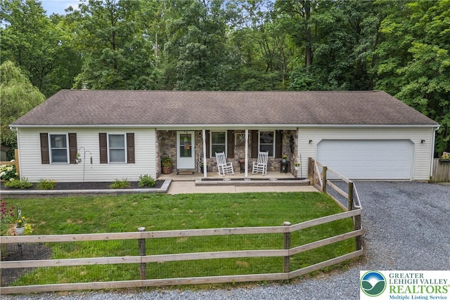 2954 Avery Rd, Washington Twp, PA 18080 - ranch-style home featuring covered porch, a fenced front yard, a garage, and driveway