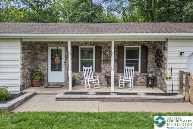 2954 Avery Rd, Washington Twp, PA 18080 - entrance to property featuring stone siding, covered porch, and a shingled roof