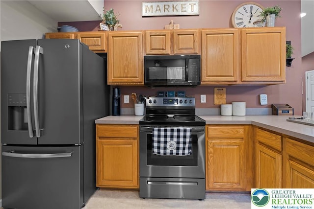 2954 Avery Rd, Washington Twp, PA 18080 - kitchen featuring refrigerator with ice dispenser, black microwave, stainless steel electric stove, and light countertops