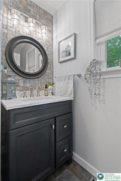 2954 Avery Rd, Washington Twp, PA 18080 - bathroom featuring vanity, wood finished floors, and backsplash
