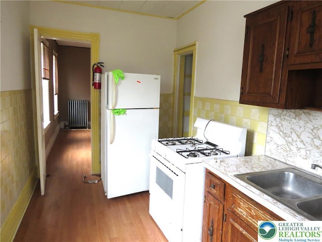 151 W Nesquehoning St, Easton, PA 18042 - kitchen featuring white appliances, radiator, wood finished floors, and light countertops