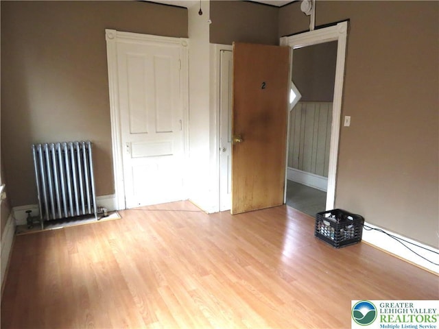 151 W Nesquehoning St, Easton, PA 18042 - empty room featuring radiator heating unit and wood finished floors