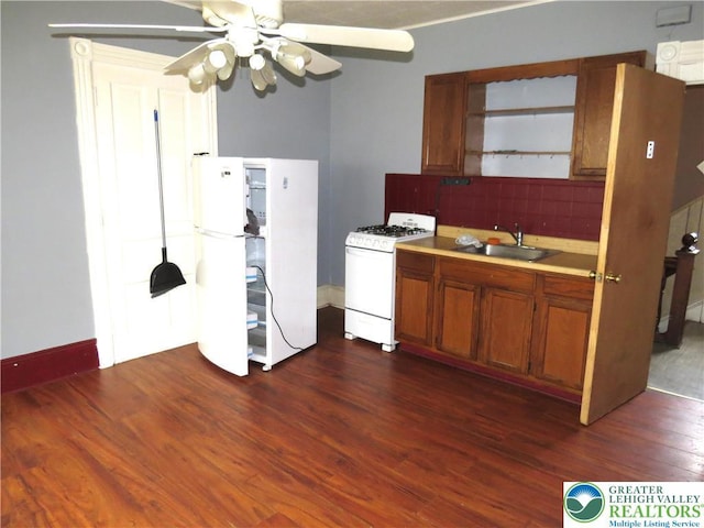 151 W Nesquehoning St, Easton, PA 18042 - kitchen featuring white appliances, brown cabinetry, dark wood-style flooring, light countertops, and backsplash