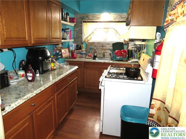 151 W Nesquehoning St, Easton, PA 18042 - kitchen featuring gas range gas stove, dark wood finished floors, brown cabinetry, and light stone counters