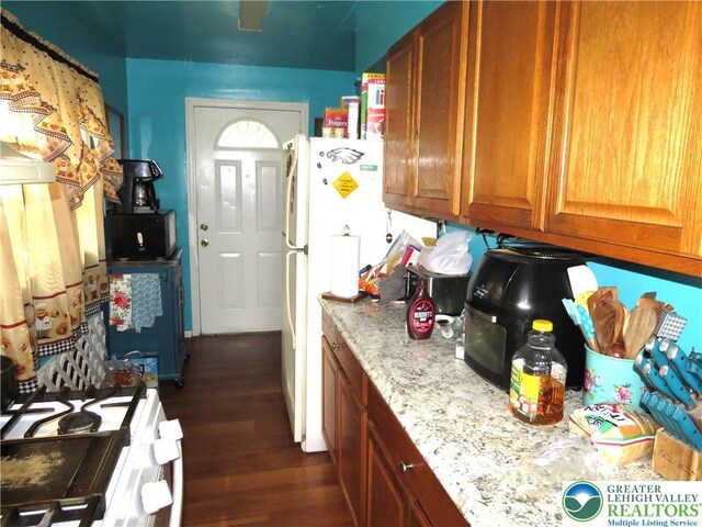 151 W Nesquehoning St, Easton, PA 18042 - kitchen featuring white appliances, dark wood-style flooring, and brown cabinetry