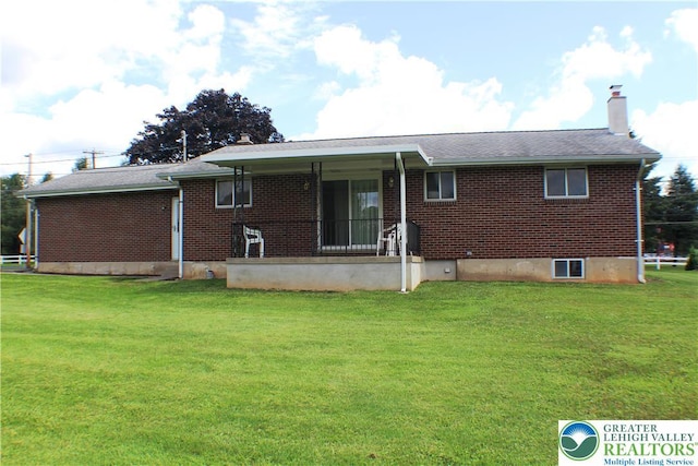 1321 Bushkill Center Rd, Bushkill Twp, PA 18091 - back of property featuring brick siding, a chimney, and a lawn
