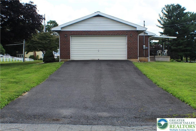 1321 Bushkill Center Rd, Bushkill Twp, PA 18091 - view of front of home with brick siding, a front yard, an attached garage, and driveway