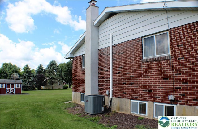 1321 Bushkill Center Rd, Bushkill Twp, PA 18091 - view of side of property with a yard, brick siding, a chimney, and a shed
