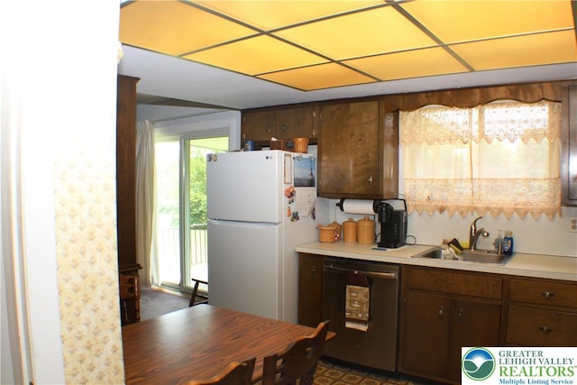 1321 Bushkill Center Rd, Bushkill Twp, PA 18091 - kitchen with dishwashing machine, freestanding refrigerator, light countertops, and dark brown cabinets