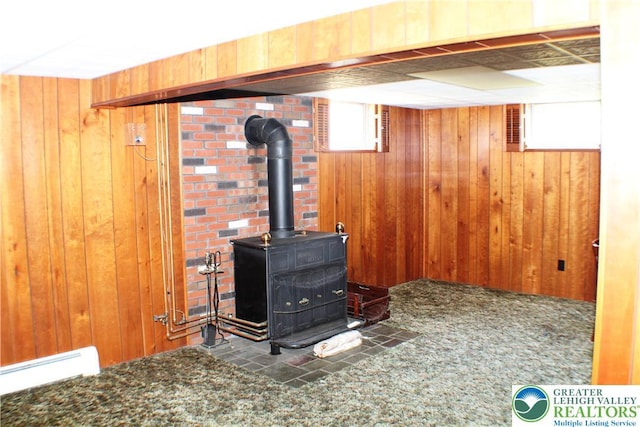 1321 Bushkill Center Rd, Bushkill Twp, PA 18091 - detailed view of wood walls, baseboard heating, and a wood stove