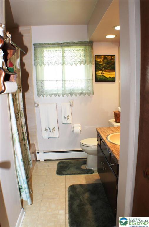 1321 Bushkill Center Rd, Bushkill Twp, PA 18091 - bathroom with a baseboard heating unit, tile patterned flooring, vanity, curtained shower, and recessed lighting