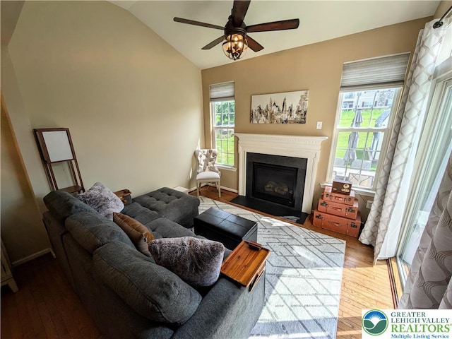 119 Gray Dr, Allen Twp, PA 18067 - living area featuring lofted ceiling, a fireplace with flush hearth, a ceiling fan, and wood finished floors