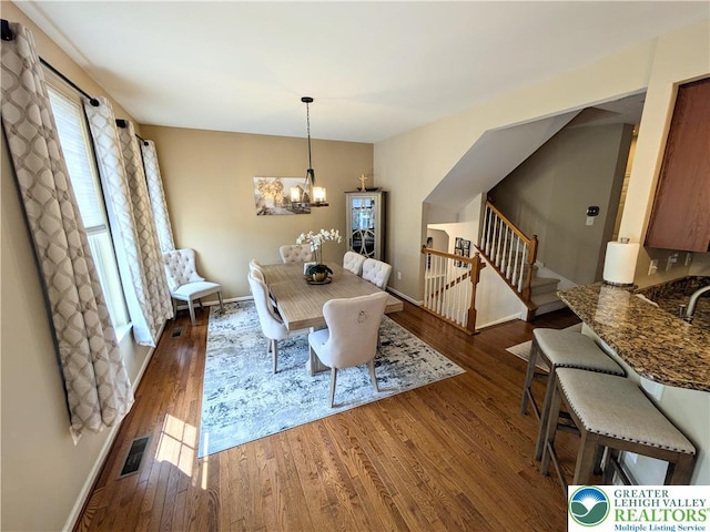 119 Gray Dr, Allen Twp, PA 18067 - dining area featuring wood finished floors, stairs, and a chandelier