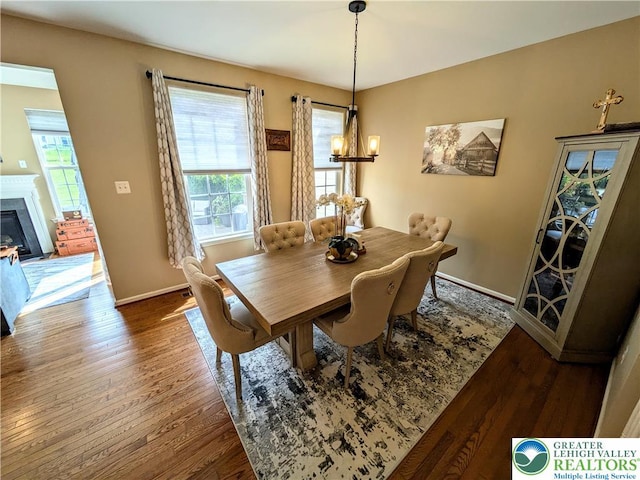 119 Gray Dr, Allen Twp, PA 18067 - dining space featuring wood finished floors, a chandelier, and a glass covered fireplace