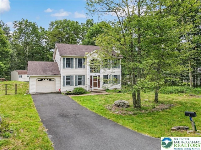5 Flagstone Ln, East Stroudsburg, PA 18302 - colonial-style house with an attached garage, asphalt driveway, and roof with shingles