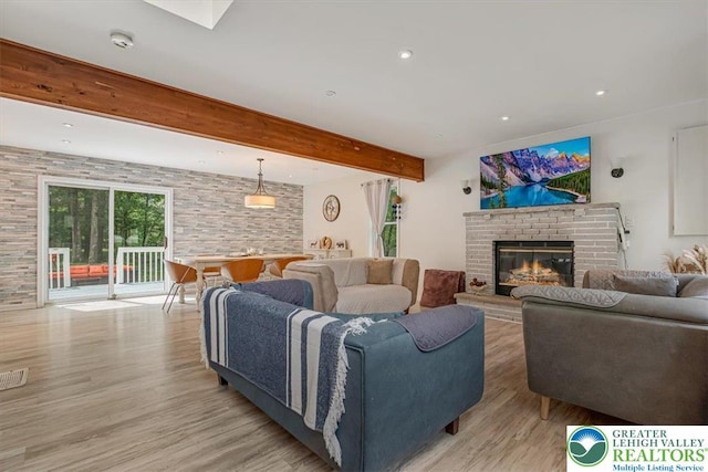 5 Flagstone Ln, East Stroudsburg, PA 18302 - living area featuring light wood-type flooring, a fireplace, beamed ceiling, and recessed lighting