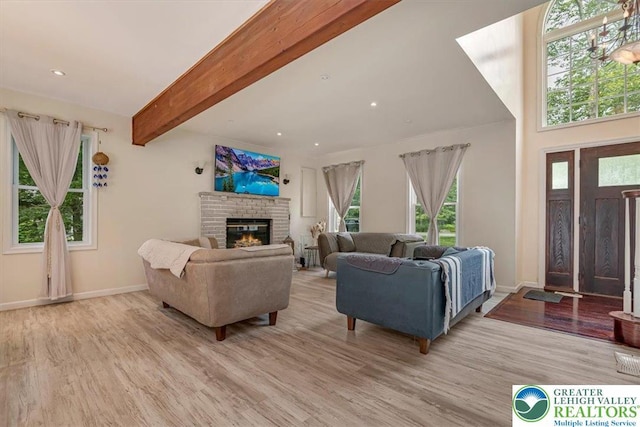 5 Flagstone Ln, East Stroudsburg, PA 18302 - living room with wood finished floors, beamed ceiling, healthy amount of natural light, a brick fireplace, and recessed lighting