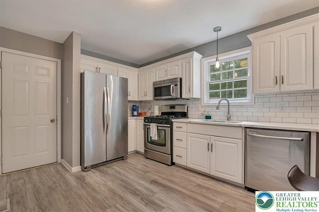 5 Flagstone Ln, East Stroudsburg, PA 18302 - kitchen with appliances with stainless steel finishes, white cabinetry, and light countertops