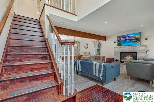 5 Flagstone Ln, East Stroudsburg, PA 18302 - living area with wood finished floors, a fireplace, stairway, beamed ceiling, and recessed lighting