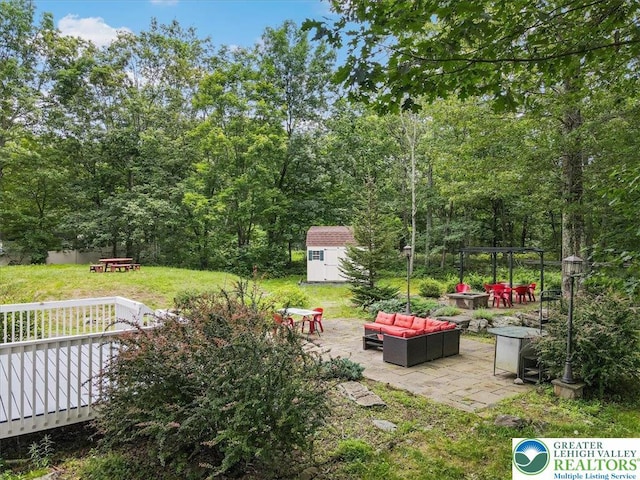 5 Flagstone Ln, East Stroudsburg, PA 18302 - view of green lawn featuring an outdoor living space with a fire pit, a storage shed, and a patio