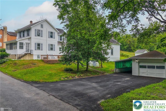 1911 Echo Rd, North Whitehall Twp, PA 18080 - view of front of home featuring a front lawn, a chimney, an outdoor structure, and driveway