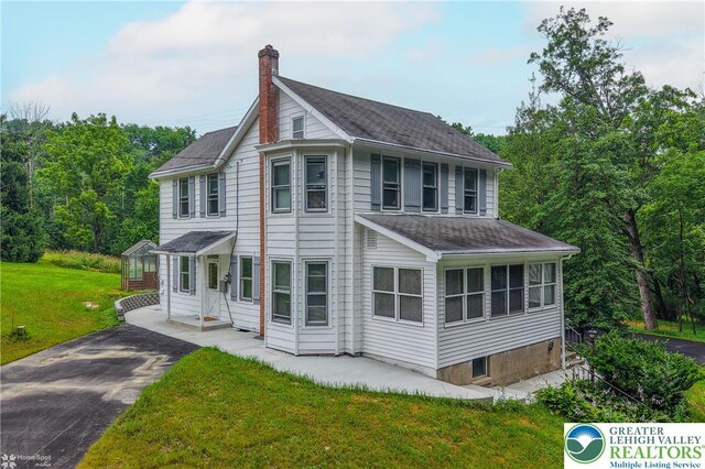 1911 Echo Rd, North Whitehall Twp, PA 18080 - view of front of home featuring a chimney, roof with shingles, and a front yard