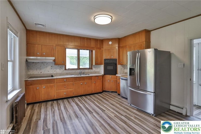 1911 Echo Rd, North Whitehall Twp, PA 18080 - kitchen with black appliances, brown cabinetry, under cabinet range hood, light wood-style floors, and light countertops