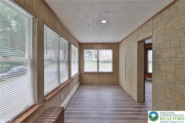 1911 Echo Rd, North Whitehall Twp, PA 18080 - unfurnished sunroom with wood finished floors, wood walls, and a baseboard radiator