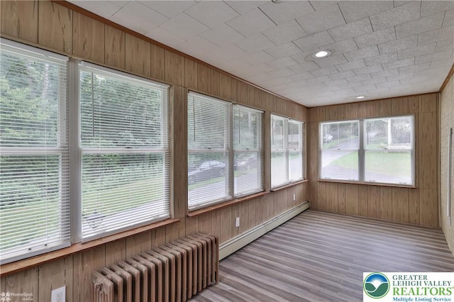 1911 Echo Rd, North Whitehall Twp, PA 18080 - unfurnished sunroom with radiator, wood finished floors, wood walls, and baseboard heating