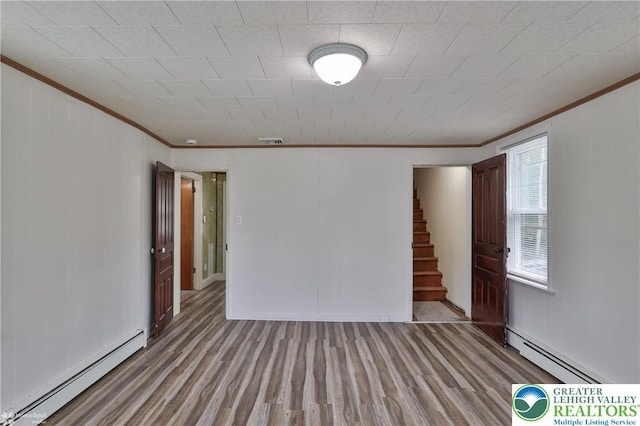 1911 Echo Rd, North Whitehall Twp, PA 18080 - empty room featuring a baseboard radiator, ornamental molding, stairs, and wood finished floors