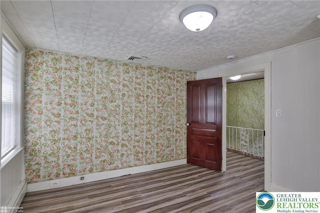 1911 Echo Rd, North Whitehall Twp, PA 18080 - spare room with wood finished floors, wallpapered walls, a baseboard heating unit, and a smoke detector