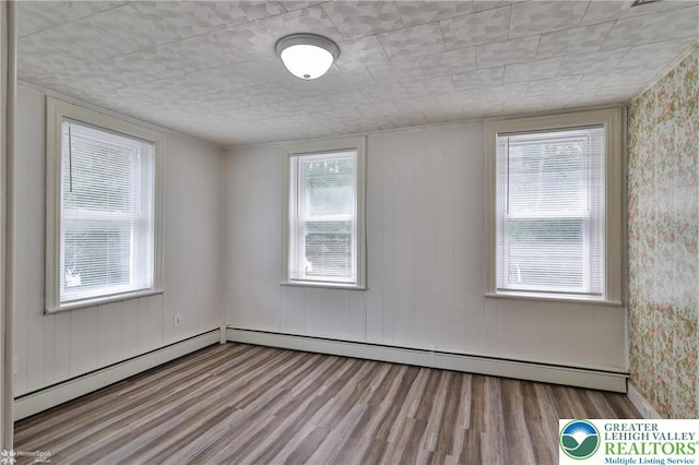 1911 Echo Rd, North Whitehall Twp, PA 18080 - spare room with wood finished floors, a baseboard heating unit, and wallpapered walls