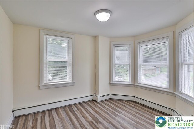 1911 Echo Rd, North Whitehall Twp, PA 18080 - spare room with baseboard heating, wood finished floors, and plenty of natural light