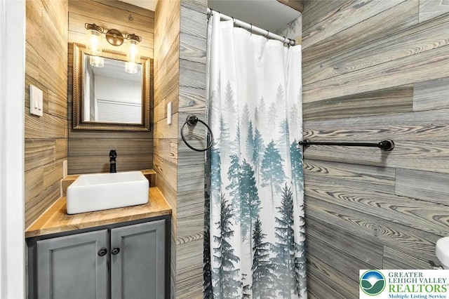 215 Tohickon Ave, Quakertown Boro, PA 18951 - full bathroom with vanity, a shower with shower curtain, and wooden walls