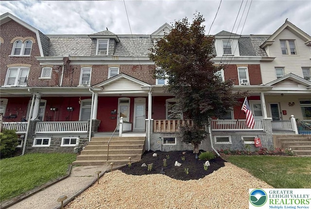 215 Tohickon Ave, Quakertown Boro, PA 18951 - victorian home with a porch, mansard roof, and brick siding