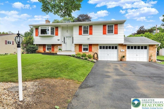 812 Miller St, Salisbury Twp, PA 18103 - split foyer home featuring driveway, a front yard, brick siding, and a chimney