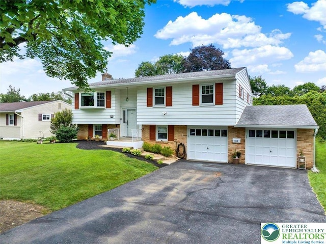 812 Miller St, Salisbury Twp, PA 18103 - bi-level home featuring brick siding, a chimney, driveway, and a front yard